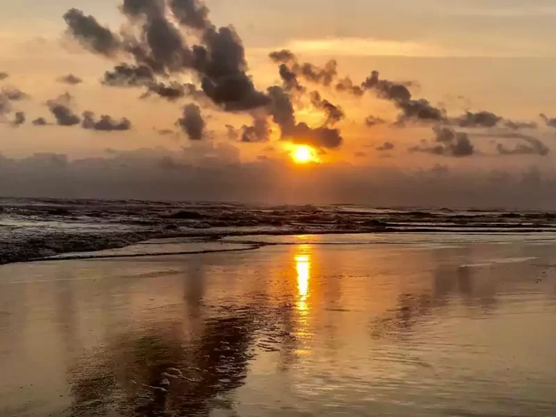 Pantai Parangtritis in Yogyakarta with black sands, cliffs, and ocean waves