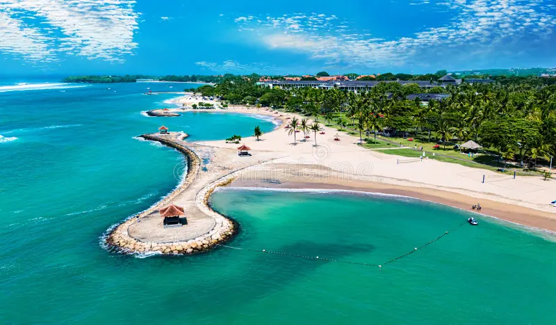 Aerial view of Nusa Dua Beach showcasing turquoise waters and white sands surrounded by lush greenery